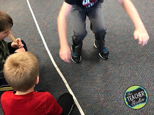 Student jumping while others watch and measure
