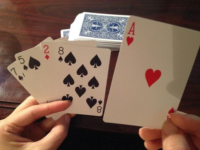 Math student holding playing cards