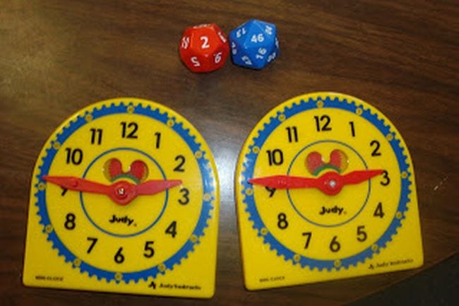 Two toy clocks and a pair of polyhedral dice