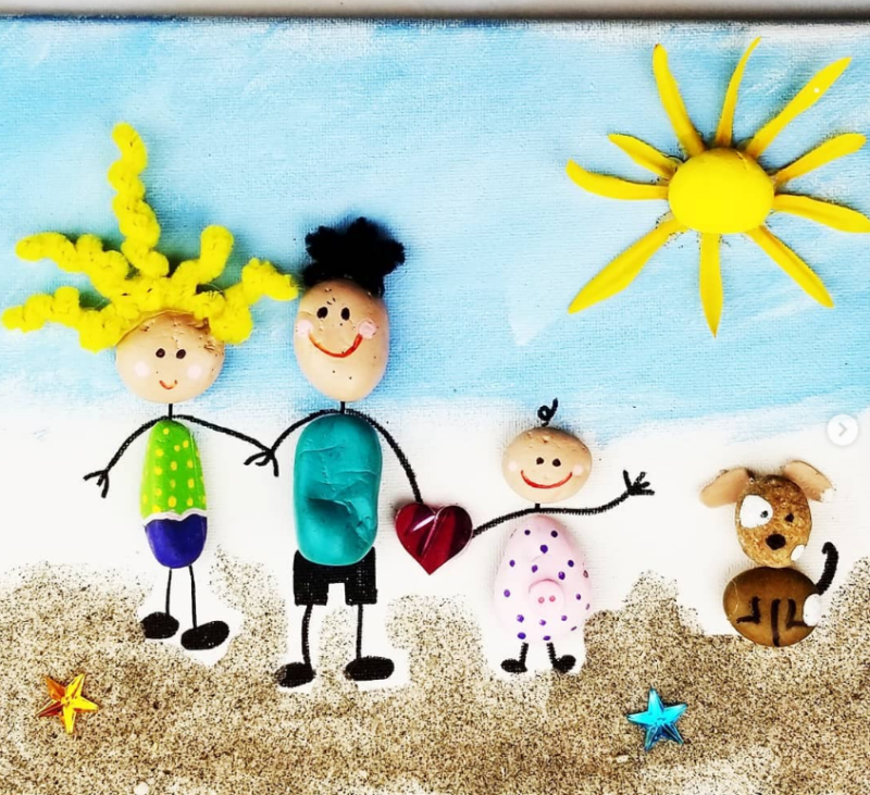 A mom, Dad, a child, and a dog are made from painted rocks in this example of Father's Day crafts for kids.